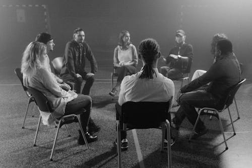 A diverse group of adults engaging in a peer support group