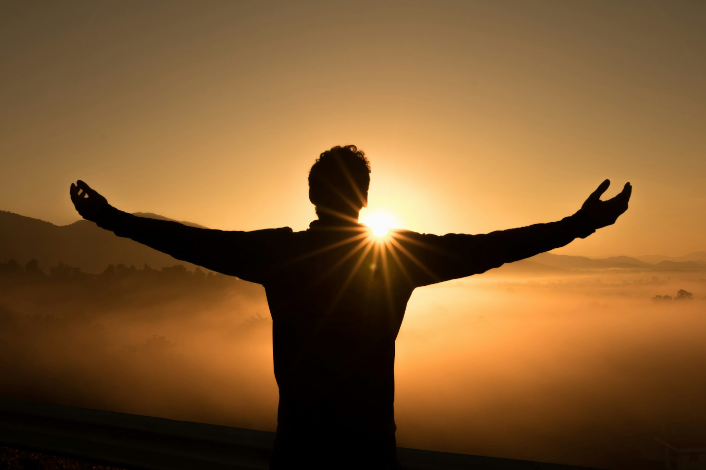 A silhouette of a man in a sunset