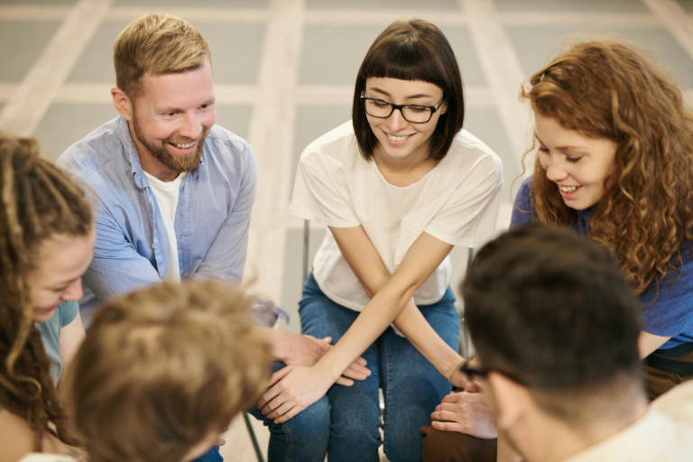 smiling group of people in a community supporting recovery