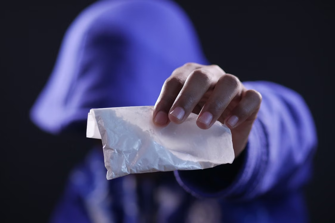 An image of a person holding a packet of pills