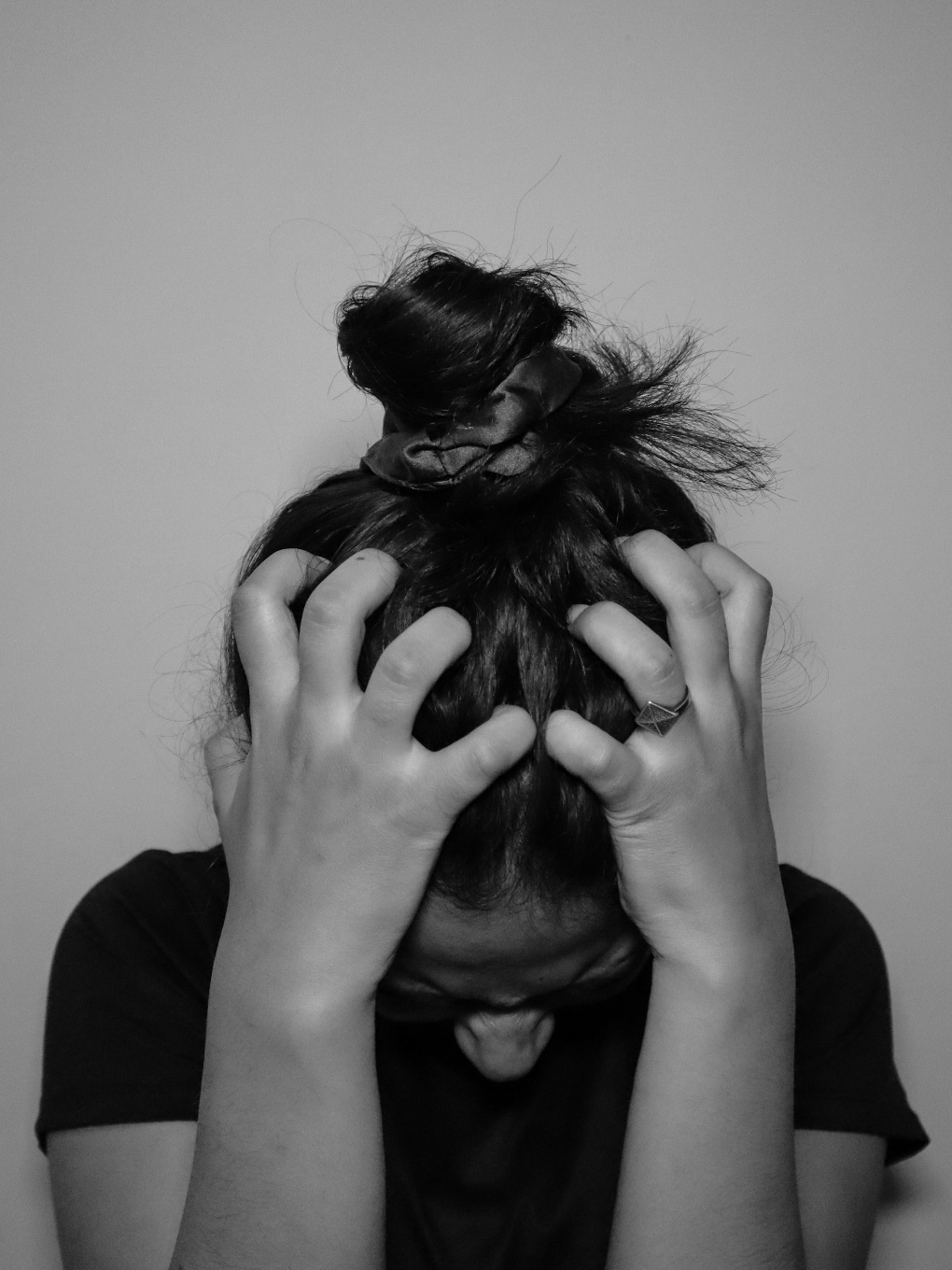 A triggered person tightly clenching their hair