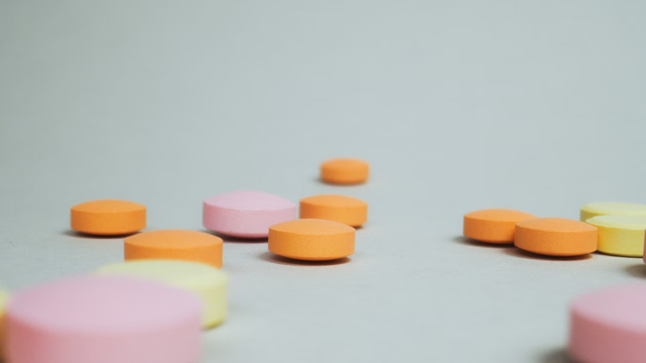 close-up of pills spilled on a white surface