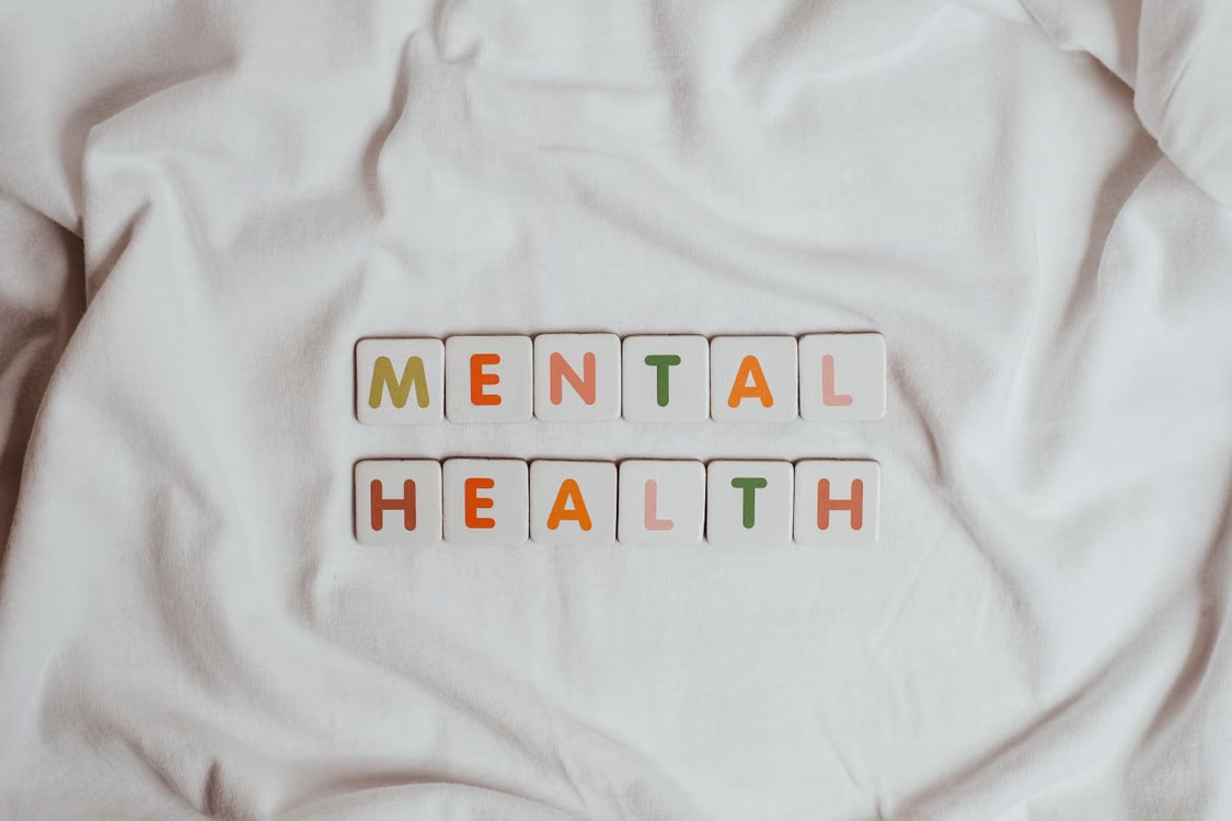 Scrabble tiles spelling “mental health”