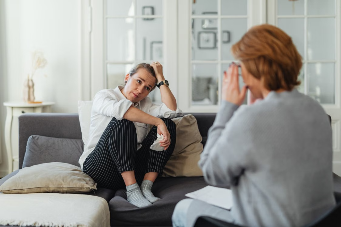 Distressed woman holding a tissue during therapy